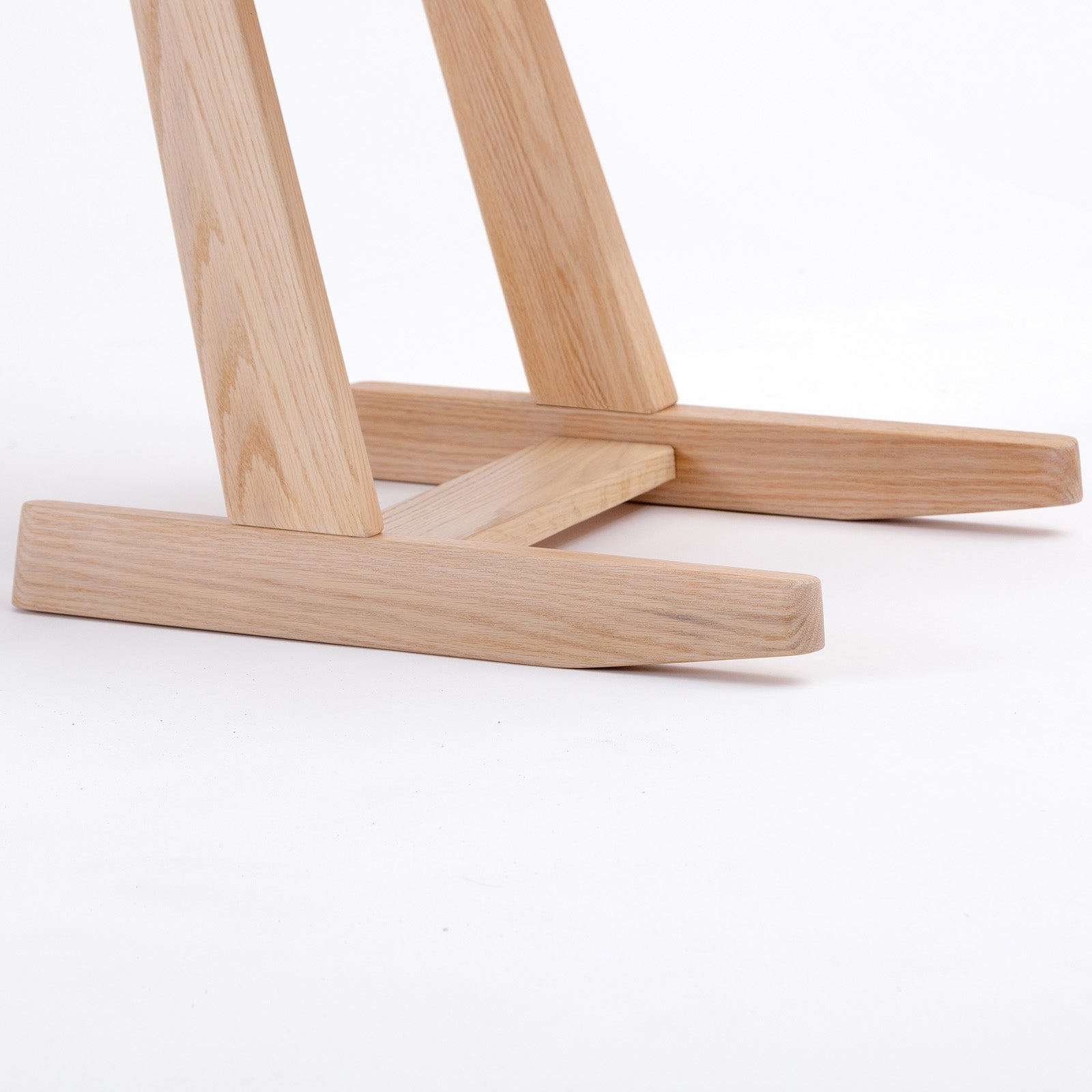 Detailed view of the KufenKarl Tip-forward - 2 position chair’s stable wooden base, designed with precision joinery for enhanced strength and durability.