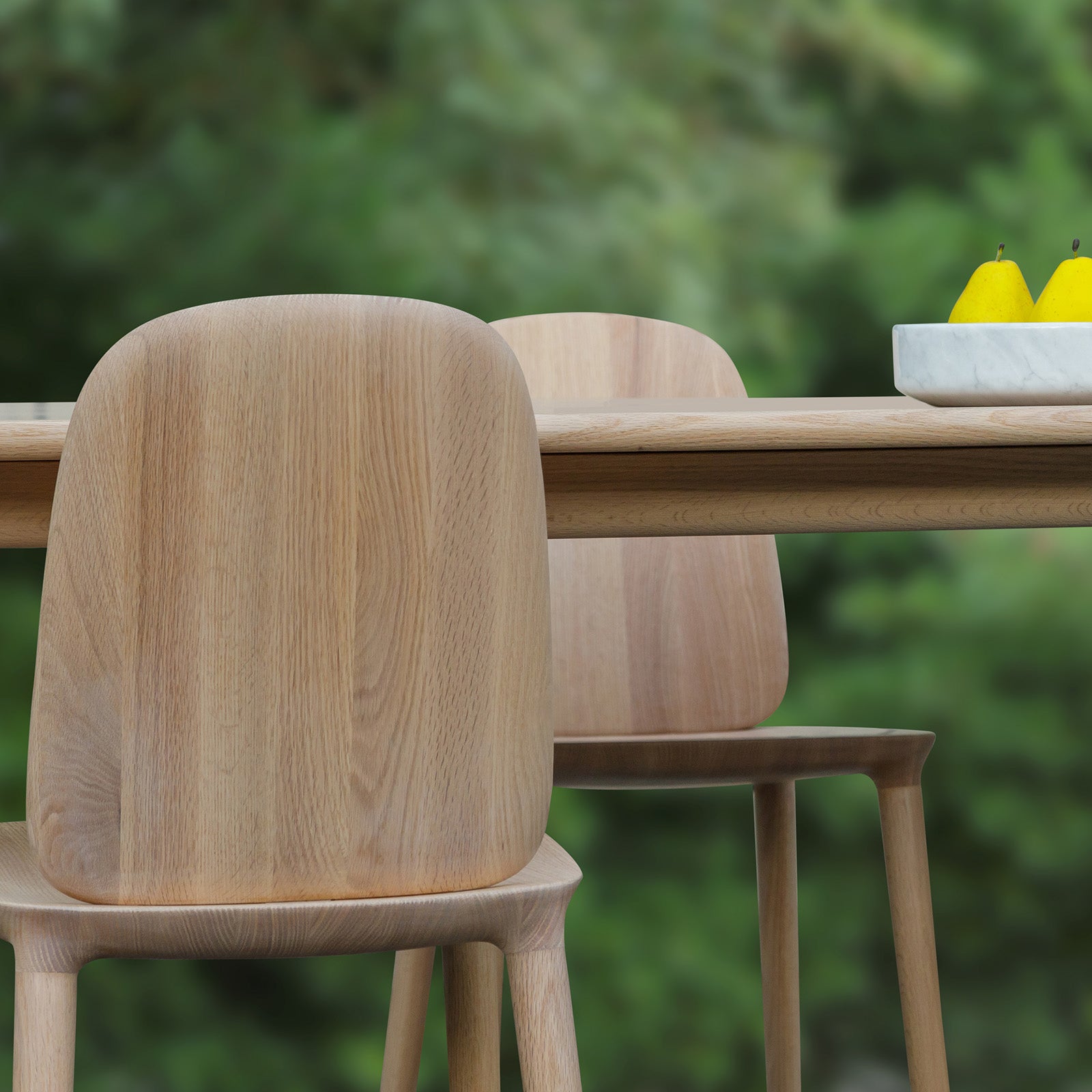 Kokoro Ottoman in natural oak finish, used as a side table, showcasing its versatility and functional design.
