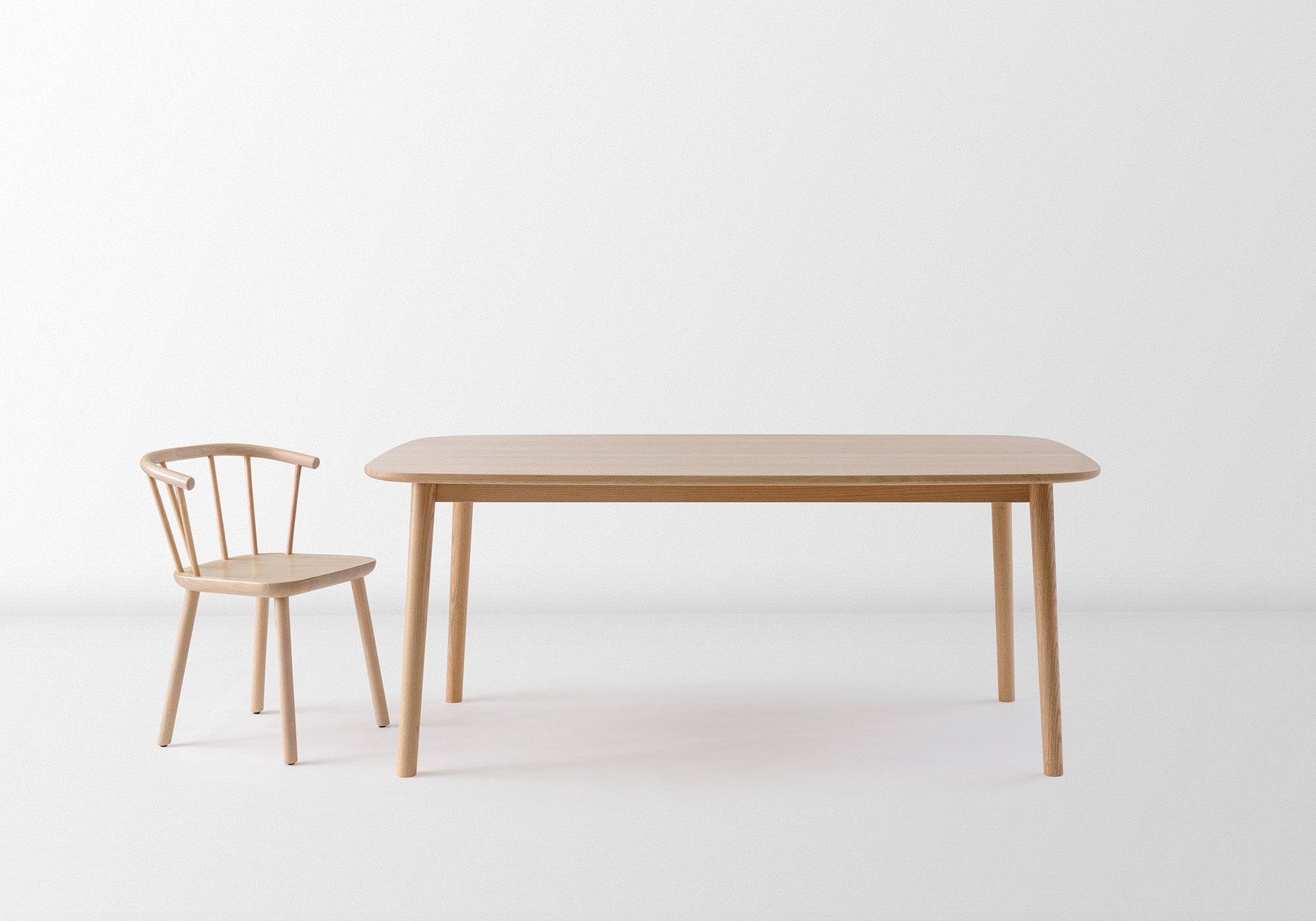 The Studio Table featuring a minimalist box-frame design, available in standard and custom sizes, made from sustainably sourced oak.