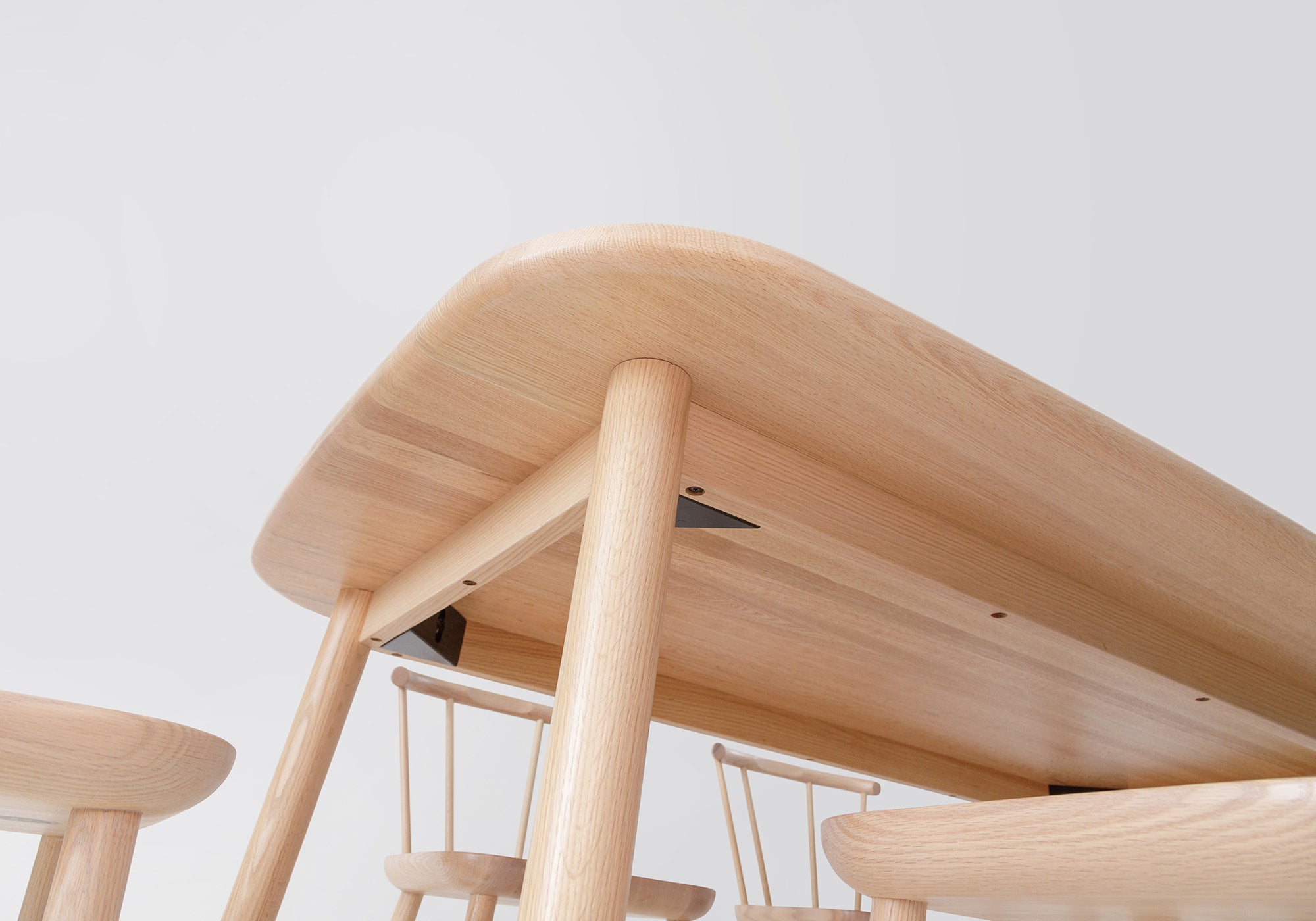 Close-up of the Studio Table’s underside, highlighting its precise joinery, natural oak craftsmanship, and durable construction.