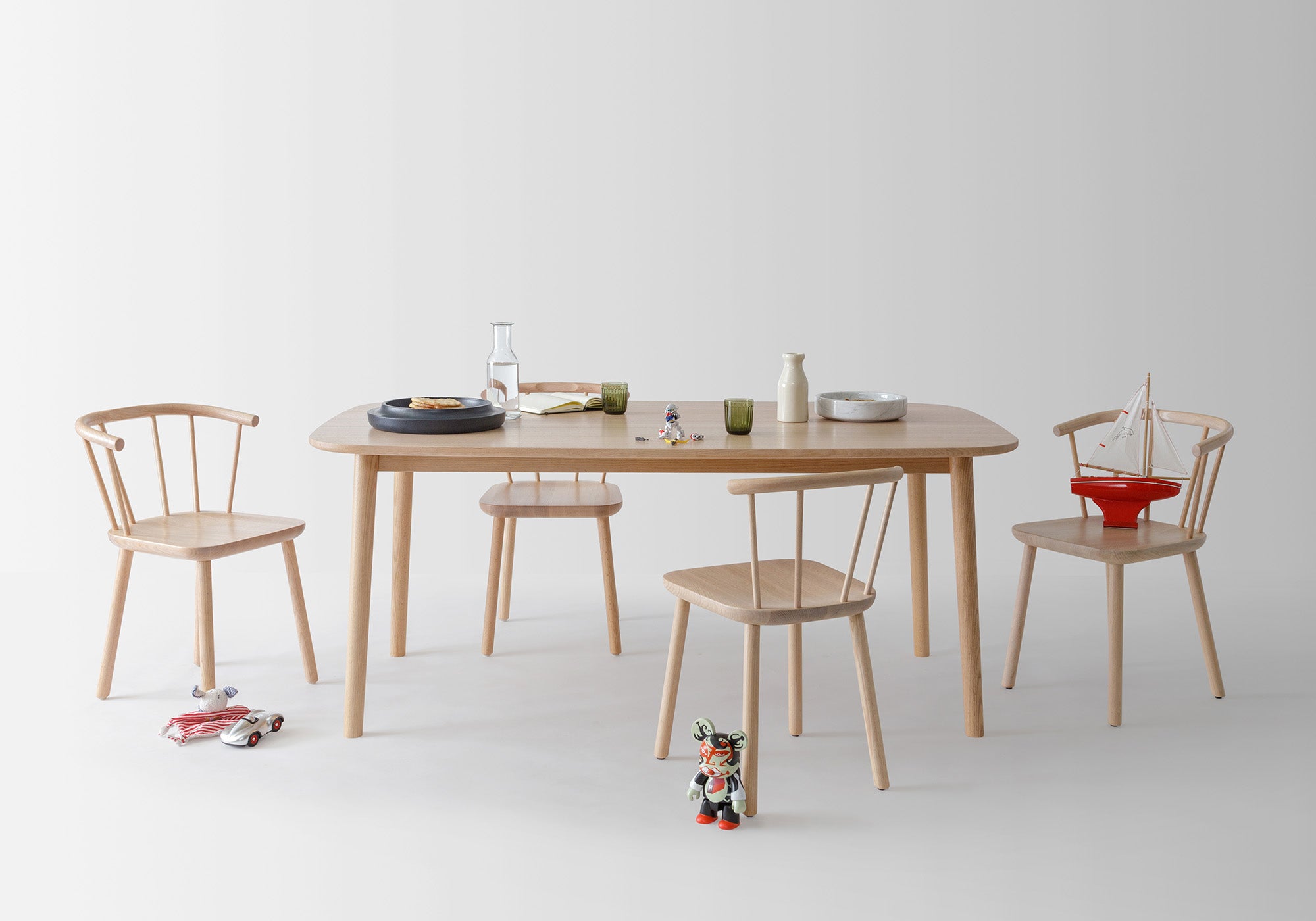 The Studio Table paired with Studio Chairs, showcased in a minimalist setting, exemplifying collect.studio's blend of traditional and modern design.