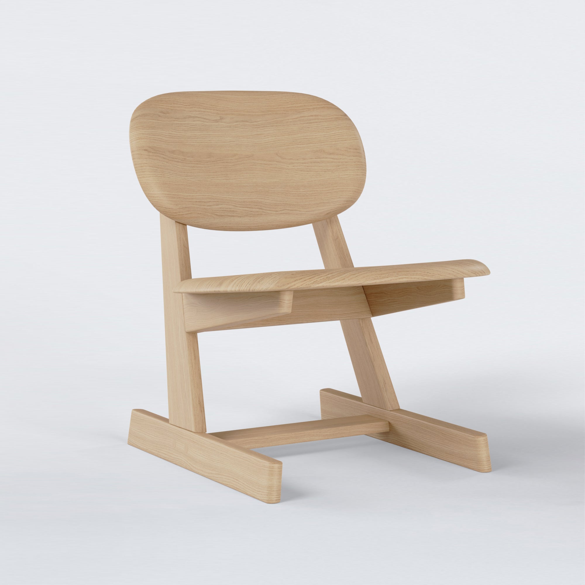 KufenKarl Lounge Chair in natural oak – angled side view, capturing the smooth, sculpted silhouette.