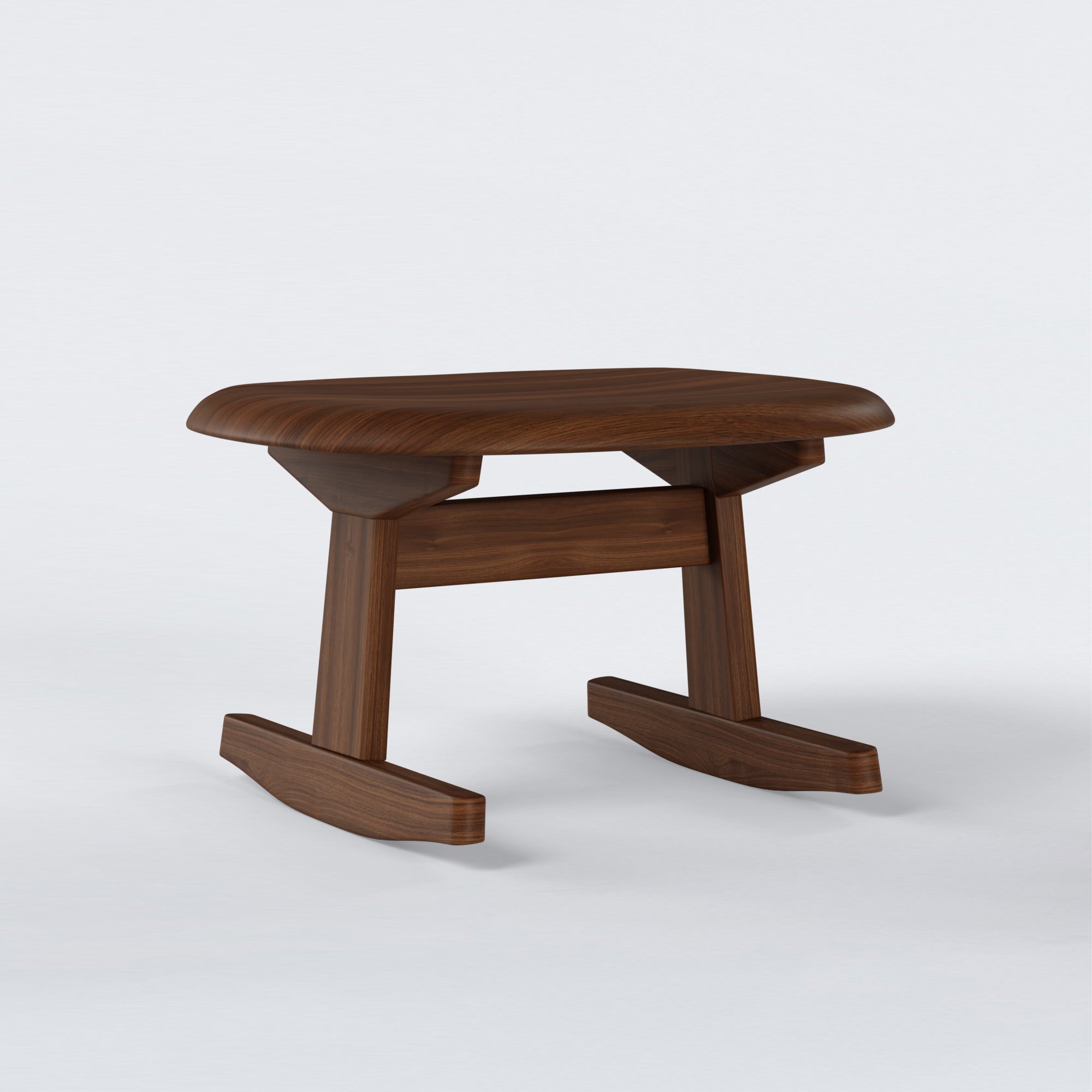 KufenKarl Rocking Ottoman in walnut – angled view, highlighting its ergonomic design and balanced proportions.