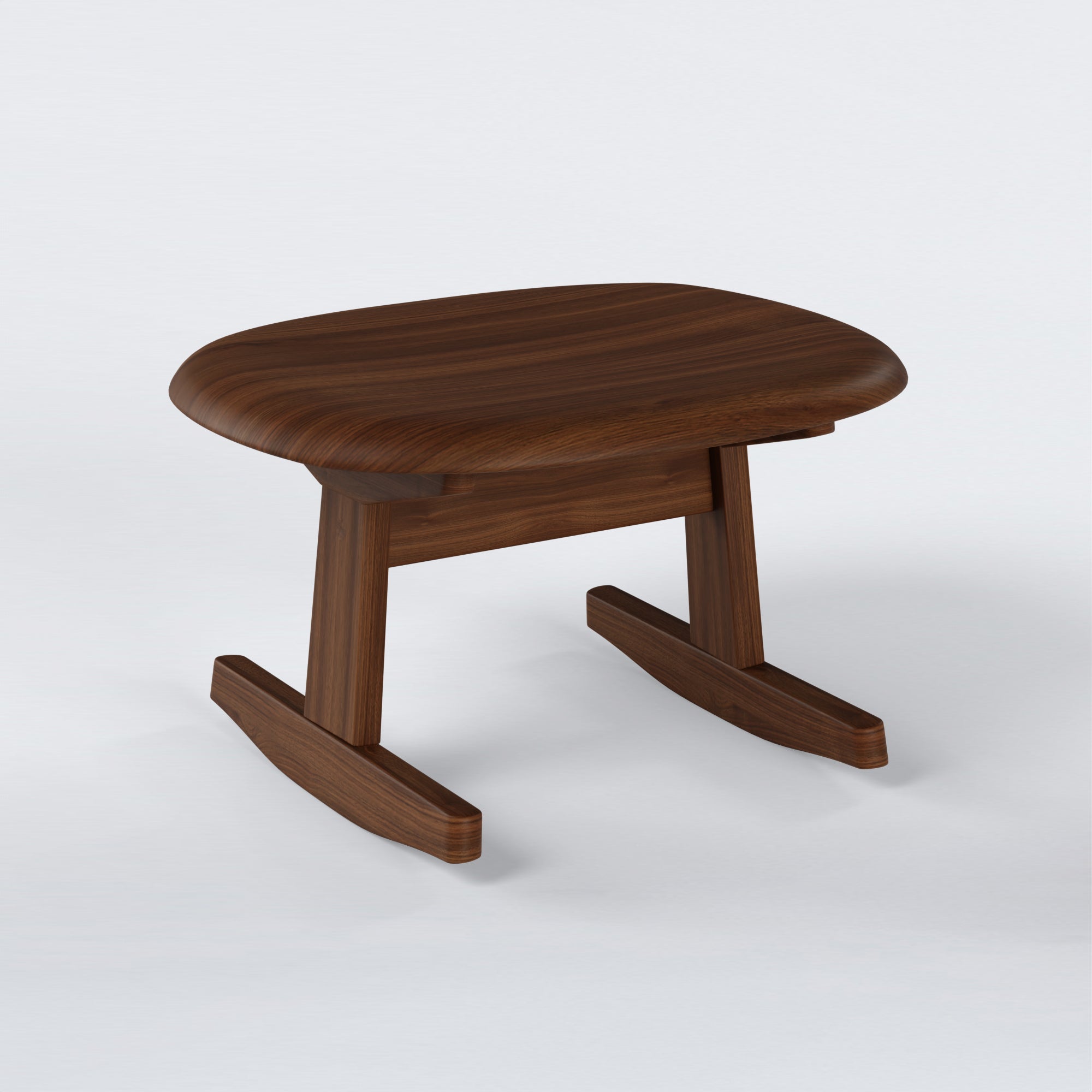 KufenKarl Rocking Ottoman in walnut – three-quarter view, capturing the overall form and refined craftsmanship.