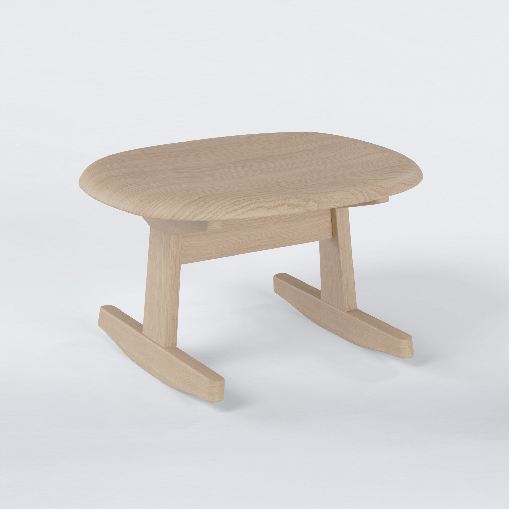 KufenKarl Rocking Ottoman in natural oak – three-quarter view, emphasizing the fluid connection between seat and base.