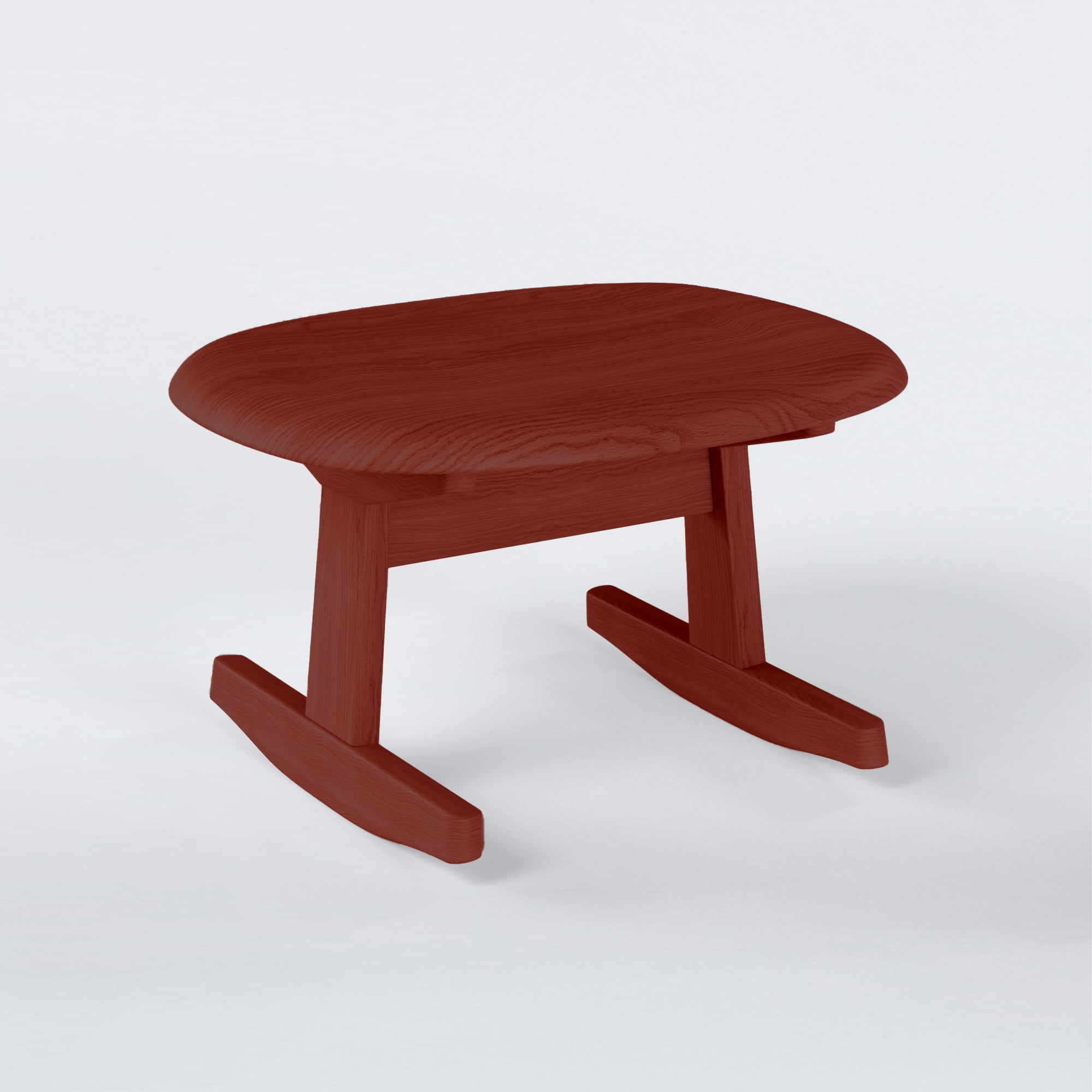 KufenKarl Rocking Ottoman in red-stained oak – bold and dynamic, enhancing its timeless appeal.