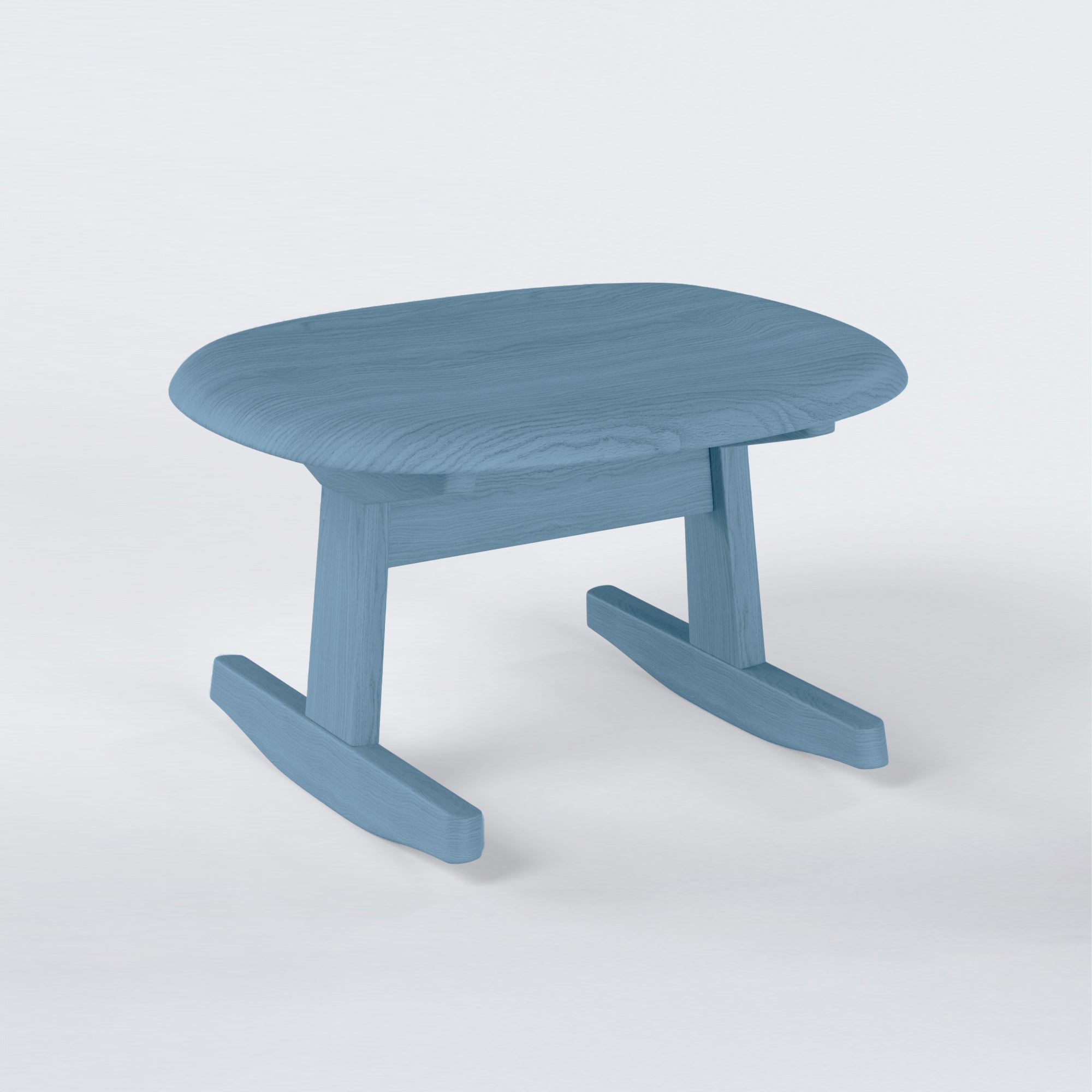 KufenKarl Rocking Ottoman in light blue-stained oak – contemporary color option, adding a fresh and playful touch.