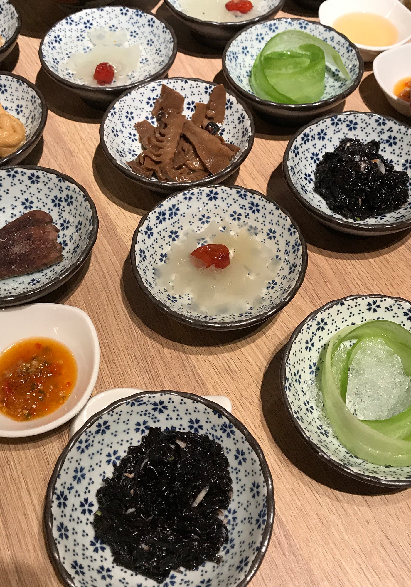 An assortment of traditional dishes served in patterned bowls, reflecting a vibrant culinary tradition.