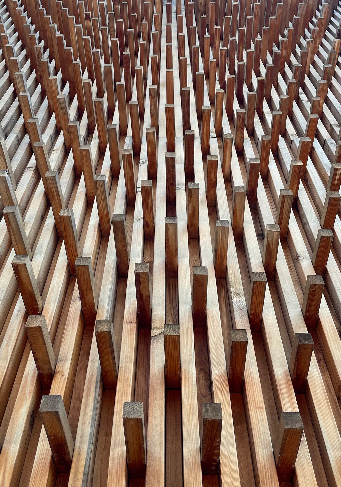 Close-up of a wooden architectural grid, highlighting its geometric precision and craftsmanship.