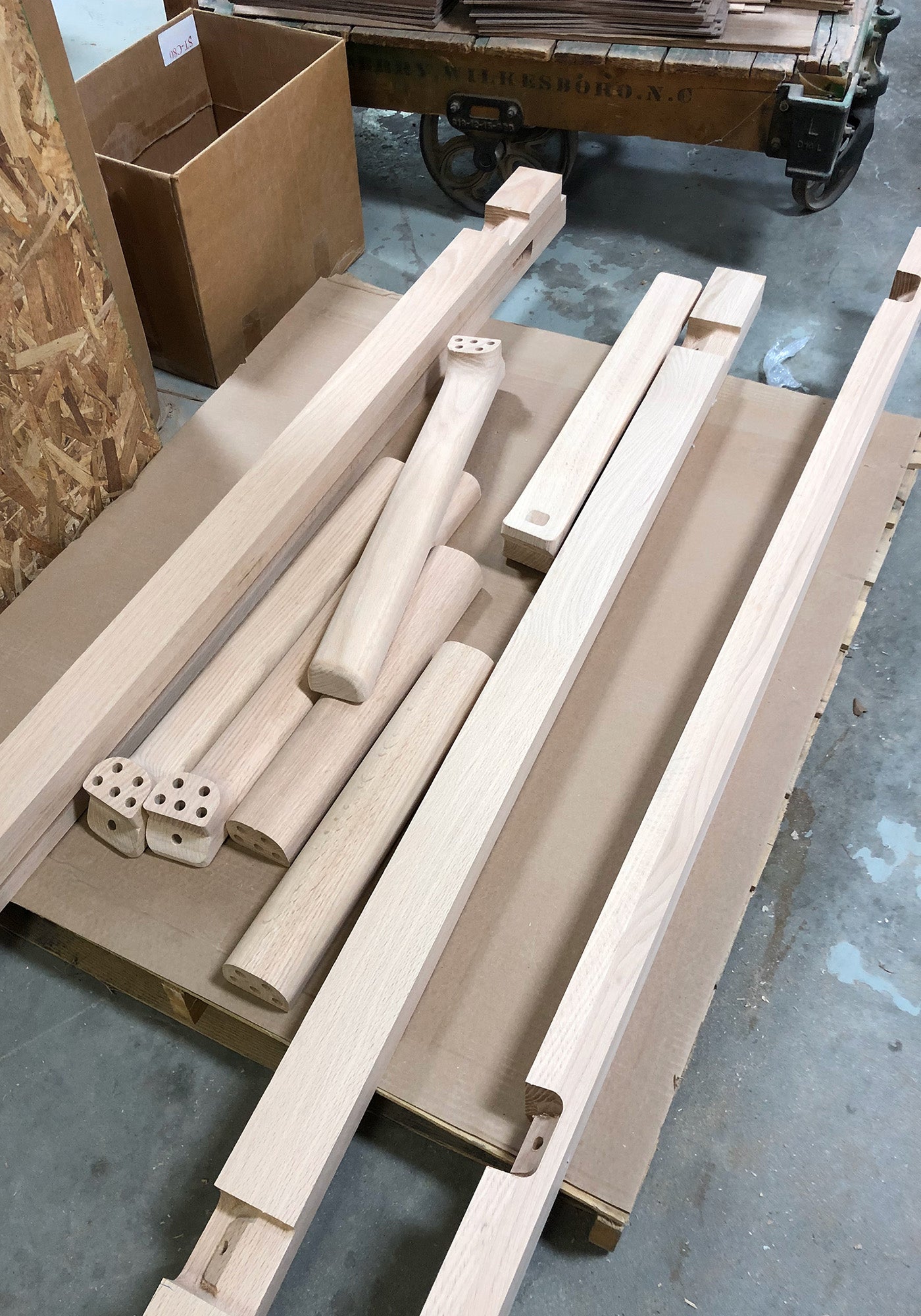 Flat-pack components of the T&B table, including bolts and legs, ready for assembly